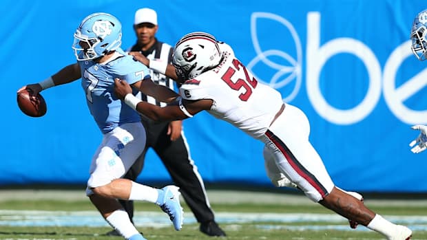 Aug 31, 2019; Charlotte, NC, USA; North Carolina Tar Heels quarterback Sam Howell (7) gets sacked by South Carolina Gamecocks defensive lineman Kingsley Enagbare (52) at Bank of America Stadium. Mandatory Credit: Jeremy Brevard-USA TODAY Sports